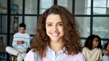 Latin Hispanic young female student standing looking at camera. Headshot.